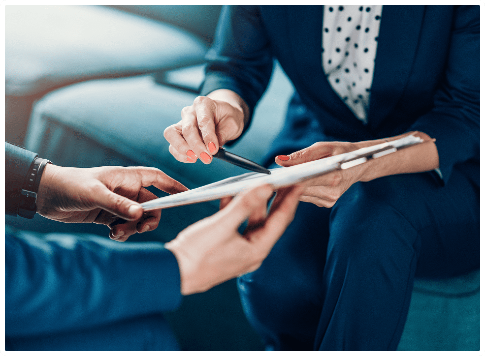 GettyImages-1157633068 A man in a suit and tie cutting something with scissors.